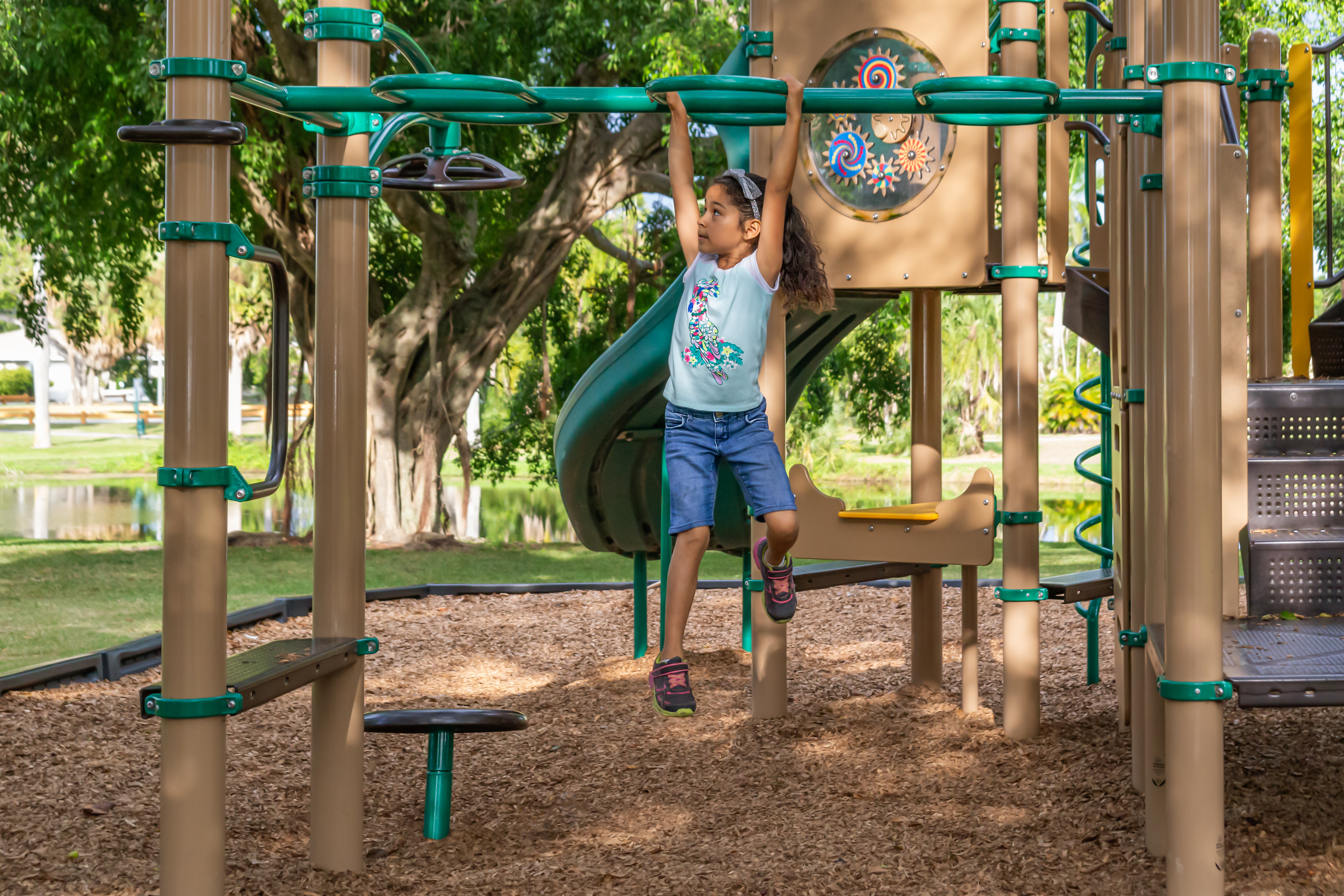 Estate management play area. Child using outdoor gym.